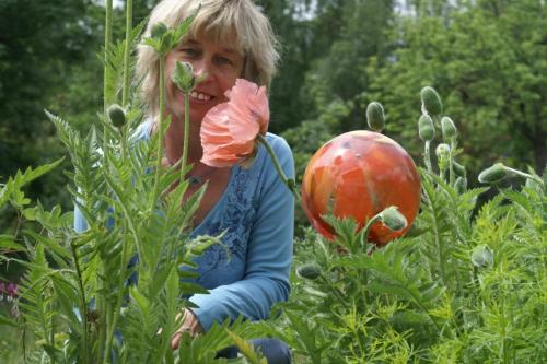 a woman standing in a field of plants at Vreni's Gästezimmer in Himmelried