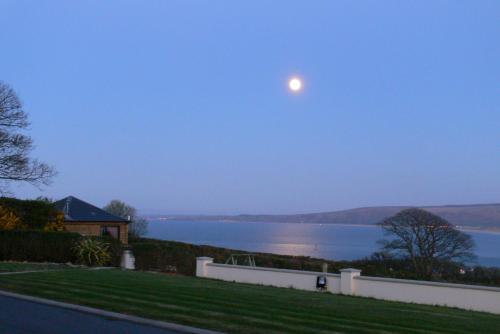 
a view from a balcony of a house overlooking a body of water at Templeview Lodge in Greencastle
