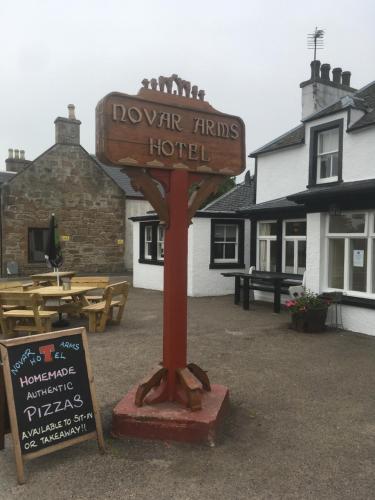 a sign for a hotel in front of a restaurant at Novar Arms Hotel in Evanton
