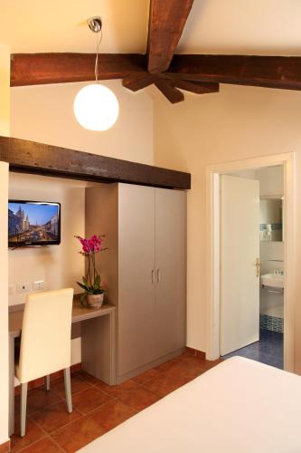 a dining room with a table and a chair at Hearth Hotel in Rome