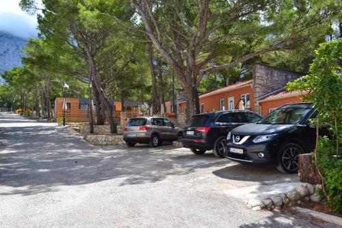 a group of cars parked on the side of a street at Apartments and Mobile Homes Makarska in Makarska
