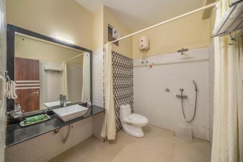 a bathroom with a toilet and a sink and a shower at Viceroy Beach And Spa Resort in Mandarmoni
