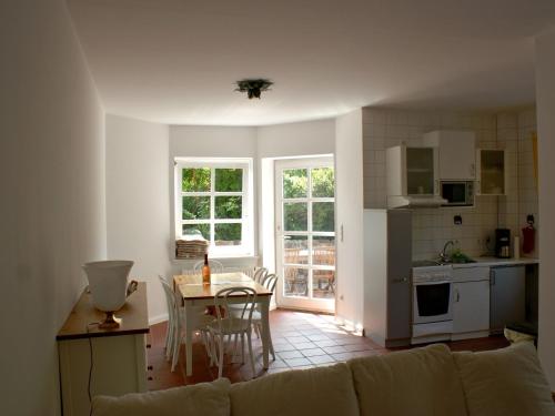 a living room with a couch and a table and a kitchen at Quaint Apartment in Semlow Germany with Garden in Semlow