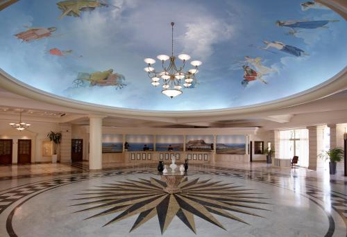 a lobby with a ceiling with fish painted on it at Lindos Princess Beach Hotel in Lartos