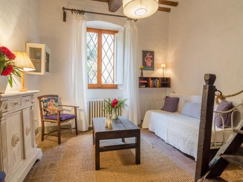 a living room with a couch and a table at Plush Farmhouse in Bacchereto with Swimming Pool in Carmignano