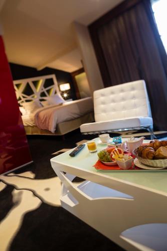 a hotel room with a table with a tray of food at Hôtel de Brienne in Toulouse