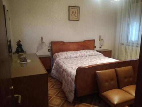 1 dormitorio con 1 cama, 1 mesa y 1 silla en Spazioso appartamento indipendente, en Apecchio