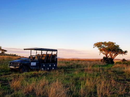 a jeep in the middle of a field at Nambiti Plains Lodge in Nambiti Private Game Reserve