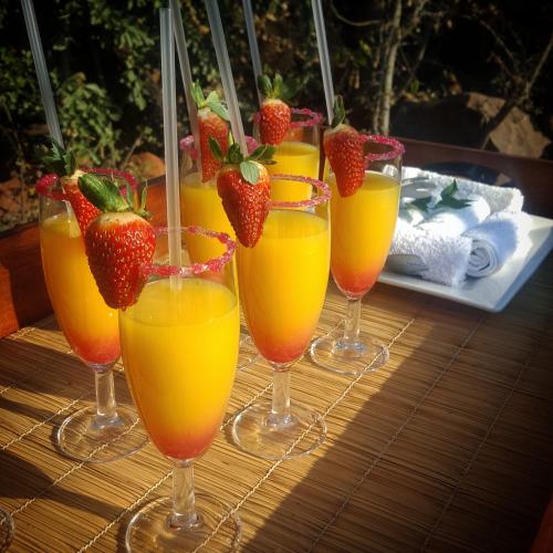 a group of glasses with strawberries in them on a table at Nambiti Plains Lodge in Nambiti Private Game Reserve