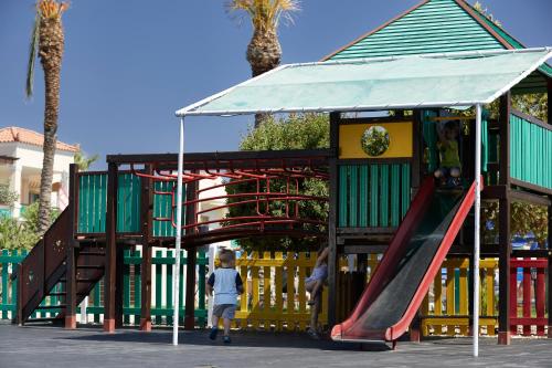 a playground with a slide in a play structure at Lindos Princess Beach Hotel in Lardos