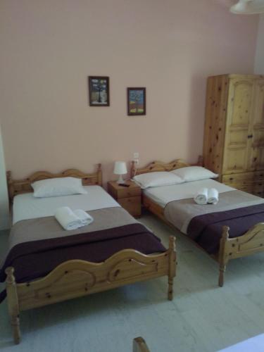 a bedroom with two beds with towels on them at Anastasia Chalatsogianni Rooms in Paralia Panteleimonos