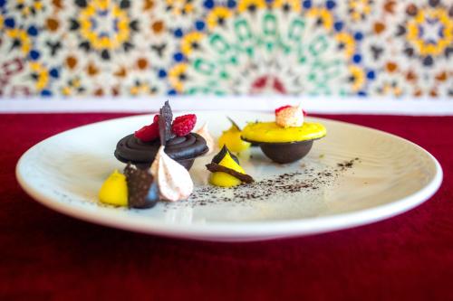 a plate of desserts on a red table at Aquafun By Grand Mogador Agdal in Marrakech