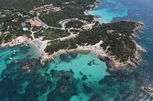 a view from a boat of a beach with a large body of water at Residenza Capriccioli in Porto Cervo