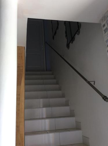 a staircase in a house with a door and a stair railing at Tercier de vigne in Chécy