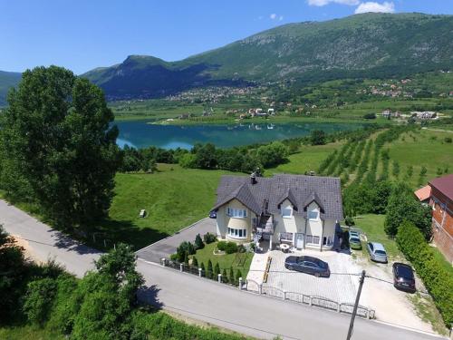 an aerial view of a house with a lake at Rooms & Apartment Jozić in Prozor