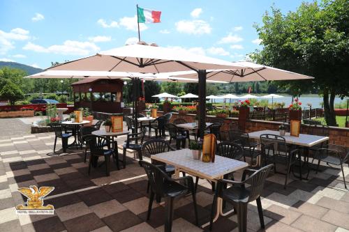 an outdoor restaurant with tables and chairs and umbrellas at Rheinhotel Bellavista in Braubach