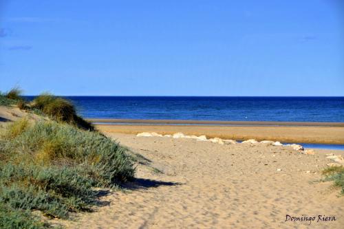 a sandy beach with the ocean in the background at Hotel Ramis fundado en 1969 in Ondara