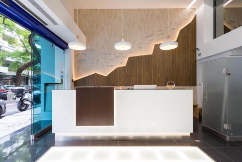 a white reception desk in front of a building at Hotel Capital Lisboa in Lisbon