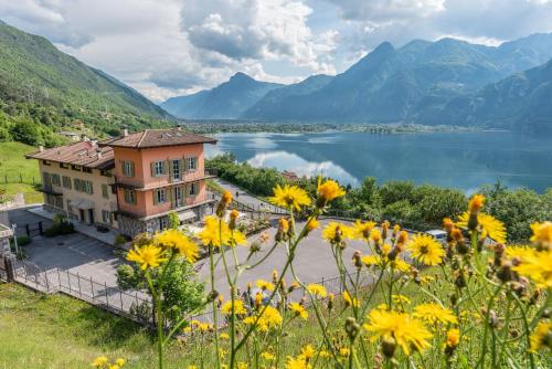 a house with a view of a lake and mountains at Garden View in Anfo