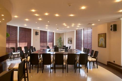 a large dining room with a table and chairs at Park Hotel Green Europe in Haskovo
