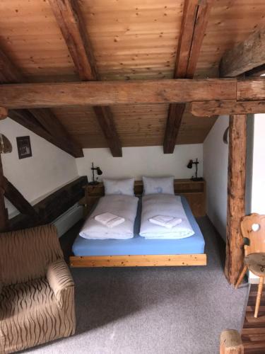 a bedroom with a bed and a couch in a room at B&B Hotel & Appartements Chasa Valär in Scuol