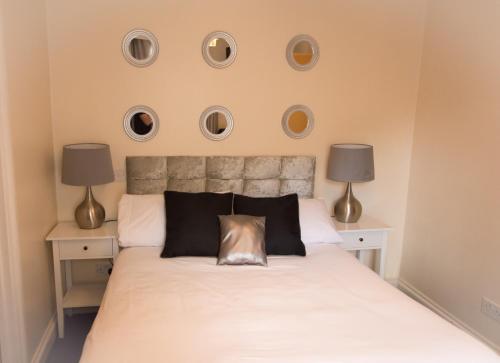 a bedroom with a bed with three plates on the wall at Castle Park Hotel in Leicester