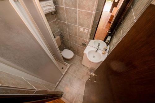 a small bathroom with a toilet and a sink at Apartments Dedić in Supetarska Draga