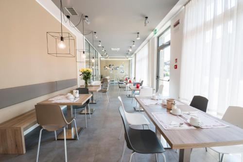 a row of tables and chairs in a restaurant at Albergo Garni Francesco in Nago-Torbole