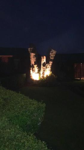 a stone structure is lit up at night at Grandpas Hotel & Restaurante in Cartago