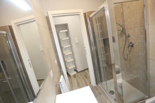 a bathroom with a shower and a toilet and a sink at SIROIKIA luxury apartments in Siracusa