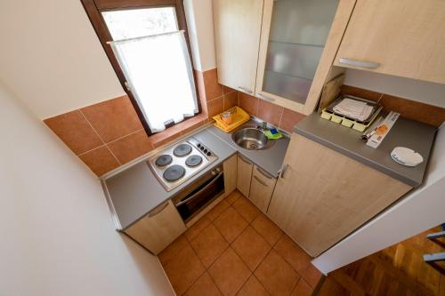 an overhead view of a small kitchen with a stove at Apartments Dedić in Supetarska Draga