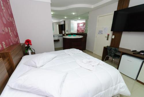 Hotel Paraiso tesisinde bir odada yatak veya yataklar