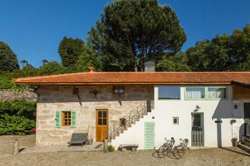 a house with bikes parked in front of it at Casa Sardão in Trofa