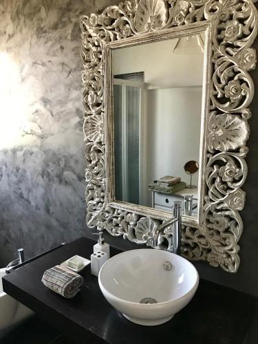 a bathroom with a white sink and a mirror at Castel Apartment in Castellamonte