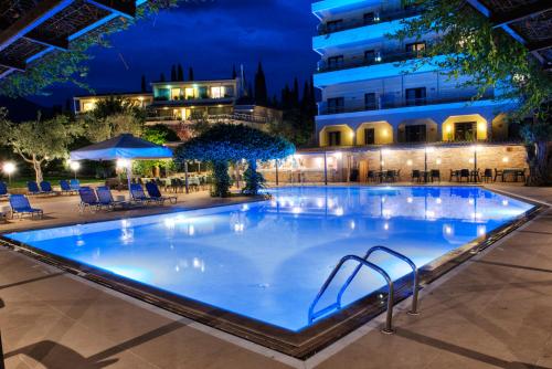 a large swimming pool at night at Miramare in Eretria