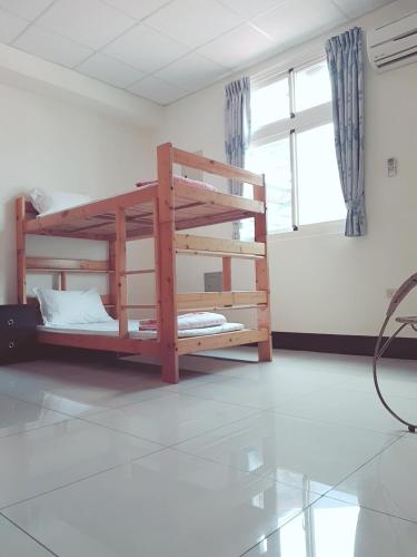 a room with two bunk beds and a window at Jinlun Village Homestay in Taimali