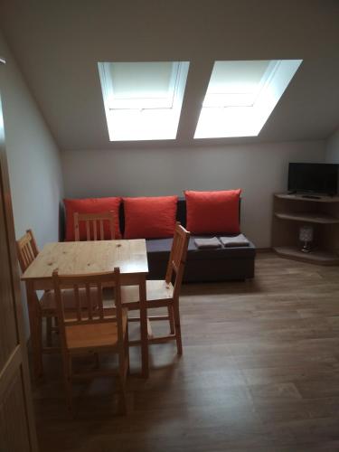 a living room with a table and a couch at Penzion Pod Kaštany Kvasice in Kvasice