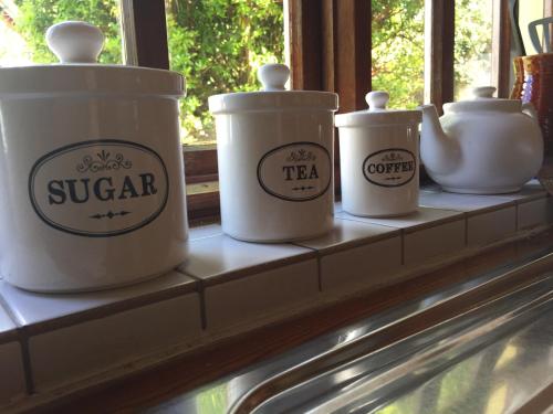 four tea pots sitting on a window sill at Wild Kerry Lodge in Glenbeigh