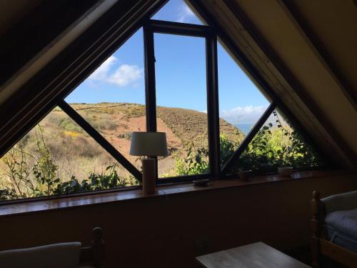 a window in a room with a view of a mountain at Wild Kerry Lodge in Glenbeigh