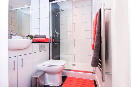 a bathroom with a toilet and a sink and a shower at Brixton Inn in London