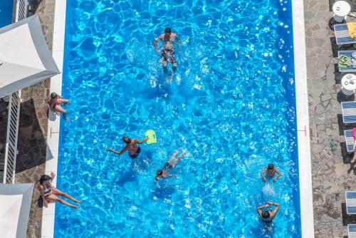 an overhead view of people swimming in a swimming pool at Hotel Baia Marina in Cattolica