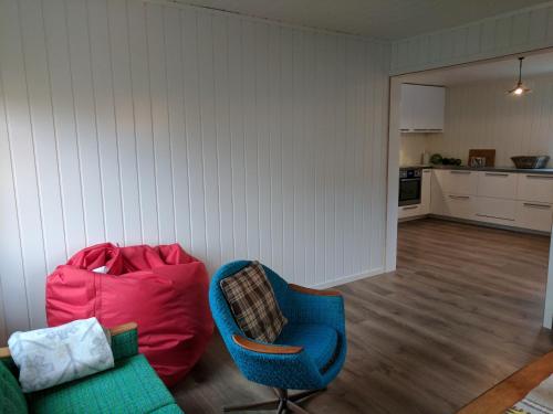 a living room with a couch and a chair at North Cape family lodge in Skarsvåg