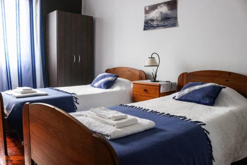 a bedroom with two beds with towels on them at Casa da Tia Adília (AL) in Ponta Delgada