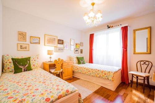 a bedroom with two beds and a window at Chesa Murmina No. 1 in Zuoz