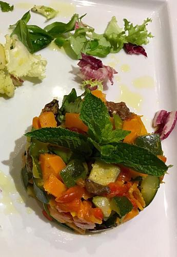 a plate of food with vegetables and greens on it at Hotel Forum in Baranzate