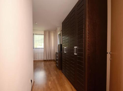 a room with a room with a wall with a television at Pravets Resort Apartments in Pravets