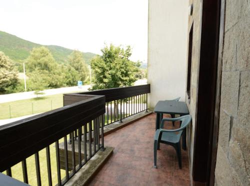 a balcony with a table and a chair on it at Pravets Resort Apartments in Pravets
