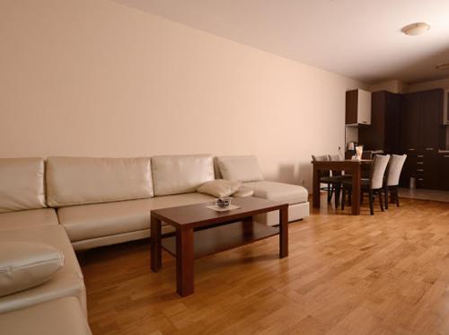 a living room with a couch and a table at Pravets Resort Apartments in Pravets