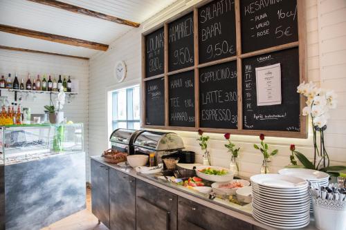 ein Restaurant mit einem Buffet mit Tellern und Speisen in der Unterkunft Hotelli Aittaranta in Uusikaupunki