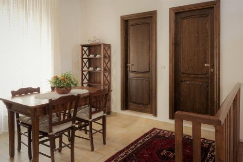 a dining room with a wooden table and chairs at Malandrì B&B in Altamura